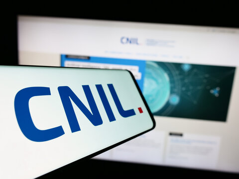 Stuttgart, Germany - 11-21-2023: Mobile phone with logo of Commission Nationale de l'Informatique et des Libert&eacute;s (CNIL) with website. Focus on center-left of phone display.
