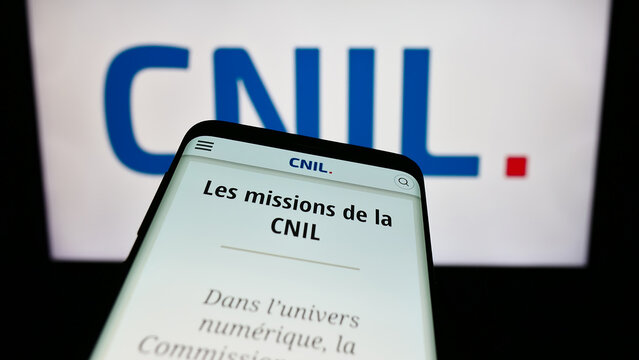 Stuttgart, Germany - 11-21-2023: Smartphone with website of Commission Nationale de l'Informatique et des Libert&eacute;s (CNIL) in front of logo. Focus on top-left of phone display.