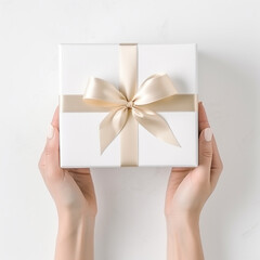 white gift box in the hands of the person on white blank background top view