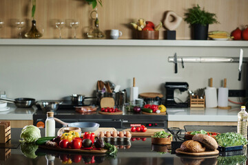 Medium shot of kitchen with food and equipment on counter and background, copy space