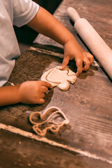 Baby's hand playing with bread dough and making shapes.