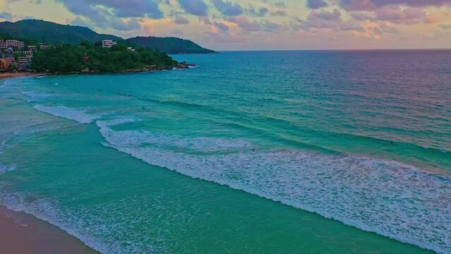 .aerial view White foam waves on the turquoise sea wash to the shore..smooth waves in blue sea at Kata beach Phuket Thailand..Nature environment background. beautiful nature in paradise beach.