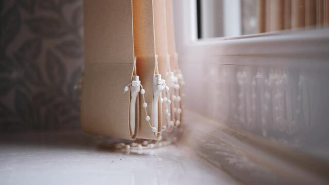 Blinds hang in the house window 