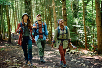 Group of young hikers walking through woods.