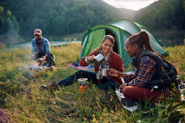 Young happy friends enjoying in camping weekend in mountains.