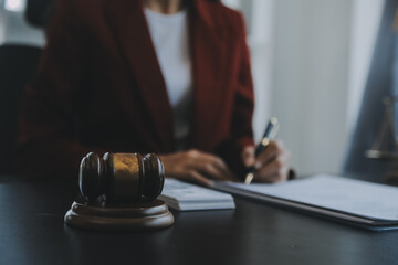 Justice and law concept.Male judge in a courtroom with the gavel, working with, computer and...