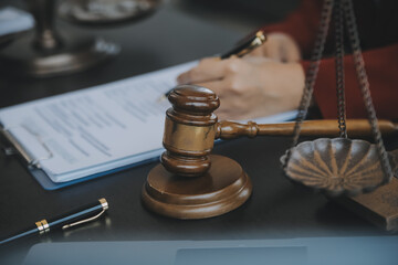 Justice and law concept.Male judge in a courtroom with the gavel, working with, computer and...