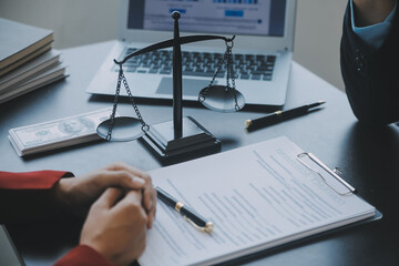 Justice and law concept.Male judge in a courtroom with the gavel, working with, computer and...