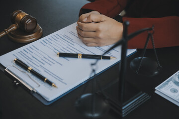Justice and law concept.Male judge in a courtroom with the gavel, working with, computer and...