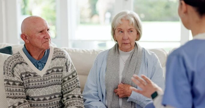 Healthcare, appointment and a nurse talking to an old couple on a sofa in the living room of their home. Medical, checkup or apartment visit with a senior man and woman speaking to a young caregiver