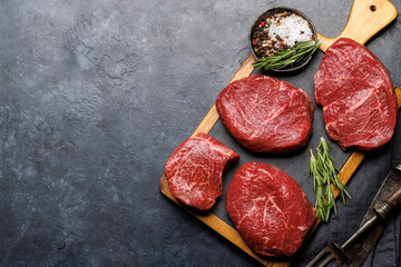 Raw beef fillet steaks on a cutting board, fresh and uncooked