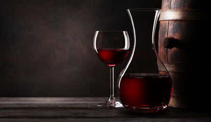 Wine decanter, glavss and old wooden barrel