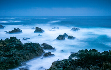 Dusk along the rocky shoreline of the Atlantic Ocean in the Costa Azul region of Portugal
