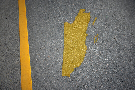 yellow map of belize country on asphalt road near yellow line.