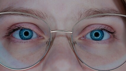Eyes of a woman wearing glasses macro shot. Vision correction. Poor eyesight.