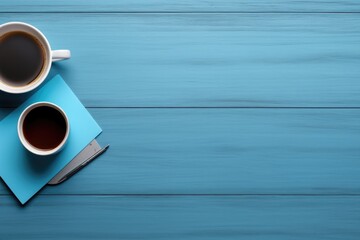 A picture of two cups of coffee placed on a blue table. Suitable for coffee shop menus or social media posts about coffee. - obrazy, fototapety, plakaty