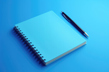 A blue notebook with a pen placed on top of it. This image can be used to represent creativity, writing, note-taking, organization, and productivity.