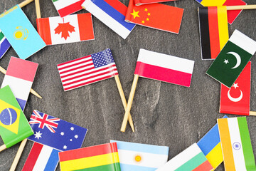 Fototapeta na wymiar The concept is diplomacy. In the middle among the various flags are two flags - USA, Poland