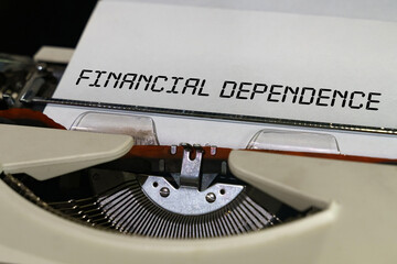 The text is printed on a typewriter - financial dependence - obrazy, fototapety, plakaty