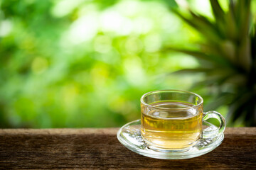 A cup of green tea on wooden table, beverage for relaxation.