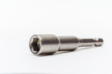 iron nozzle for roofing screws on a white background. metal adapter for screwing in self-tapping screws on a light background. reinforced bolt socket