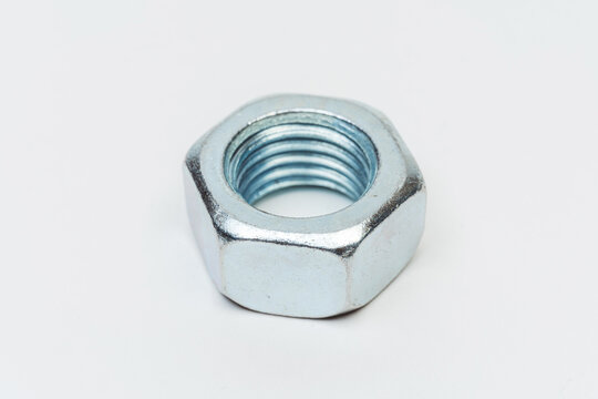 iron nut on a white background. metal nut on a light background. photos of nuts and bolts for the catalog
