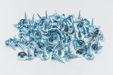 screws on a white background. photo of self-tapping screws for the catalog on a light background. set of bolts for construction work