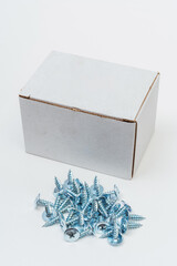 screws with packaging on a white background. photo of self-tapping screws for a catalog with a box...