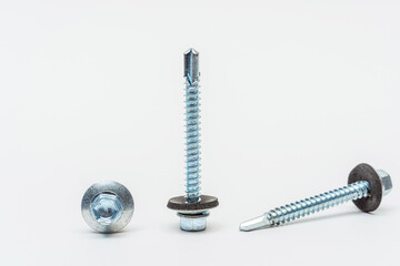roofing screws on a white background. photo of self-tapping screws for the catalog on a light...