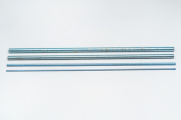iron threaded stud on a white background. metal rod with thread on a light background. construction...