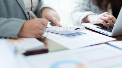 Two colleagues working analytic in office.