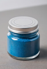 A jar of blue mineral color pigment powder.