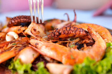 Fresh raw seafood squid shrimp oyster mussels fish with spices of herbs lemon on a light blue background copy space top view banner