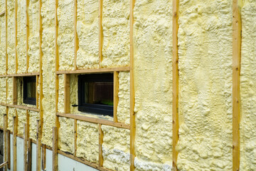 The facade of the residential house sprayed with a layer of polyurethane thermal insulation foam