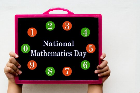 National Mathematics Day and Numbers word or text written on black chalkboard held with hand in white background.