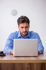 Young male employee working in the office