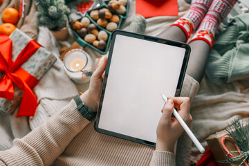 Girl working on a graphics tablet with isolated screen in a Christmas atmosphere