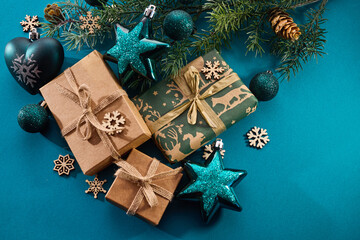 Christmas background. Gift boxes tied ribbons and christmas decorations on turquoise background.
