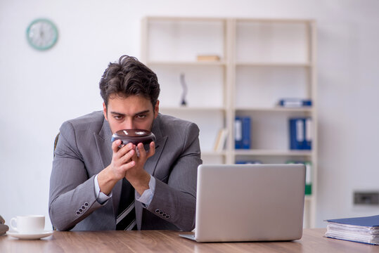 Young male drug addicted employee at workplace