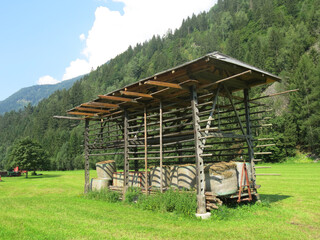 Typical European barn for drying hay in the cultivated field © ChiccoDodiFC
