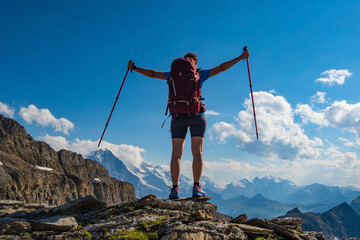 Sporty woman hiking in Switzerland alps. Heathy lifestyle, sport, beauty in nature. Grindelwald valley, Swizz - obrazy, fototapety, plakaty
