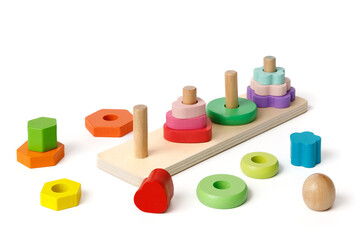 Montessori wooden children's puzzle toy with colorful blocks of different shapes in the shape of 4 pyramids isolated on white background.