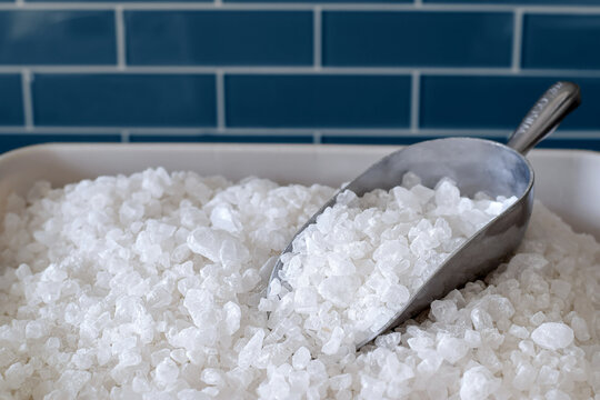 Container with water softener salt with a scoop