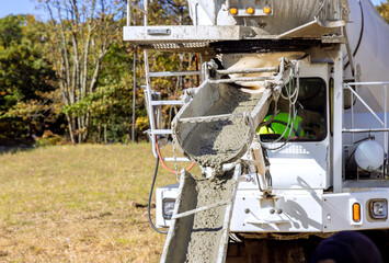 Concrete mixer truck poured liquid cement concrete at construction site