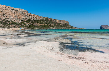Naklejka premium Panorama of the sea and the rock during a windy day at Blue lagoon in Balos, Crete, Greece. Beautiful lagoon at Mediterranean Sea. Shot taken near Gramvousa Island.