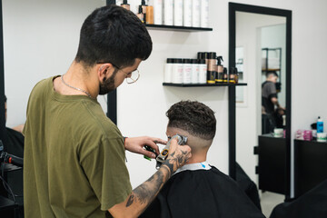 barber cutting client's hair with his back turned