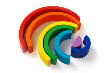 Children's wooden educational puzzle toy set in the form of a colorful rainbow isolated on white background.