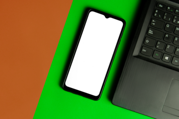 green background that contains a cell phone without a screen to fill and next to it a computer. PNG image.