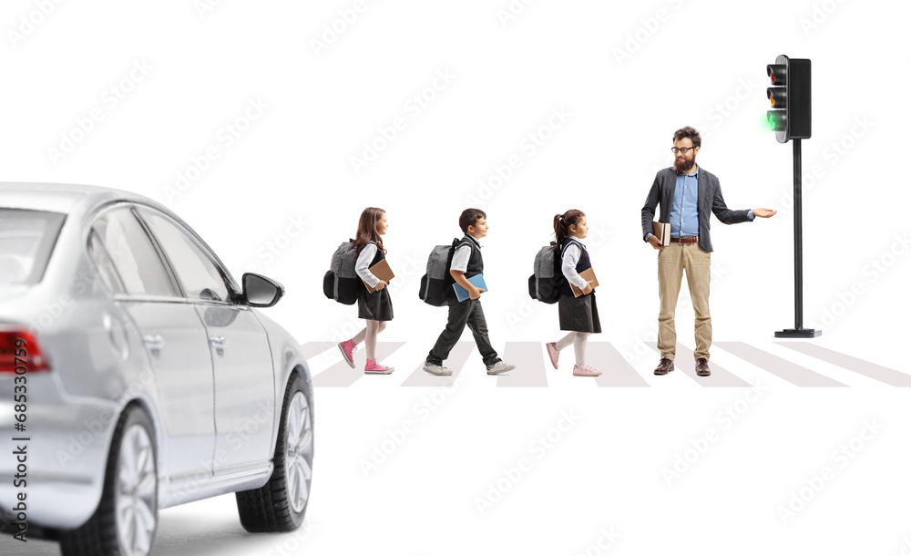 Sticker full length profile shot of schoolchildren and teacher crossing a street in front of a car