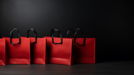 sale, consumerism and outlet concept - red shopping bag on black background